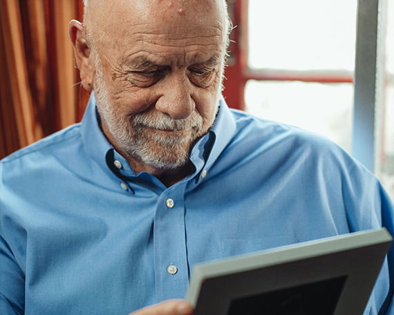 man in blue shirt looking at a picture