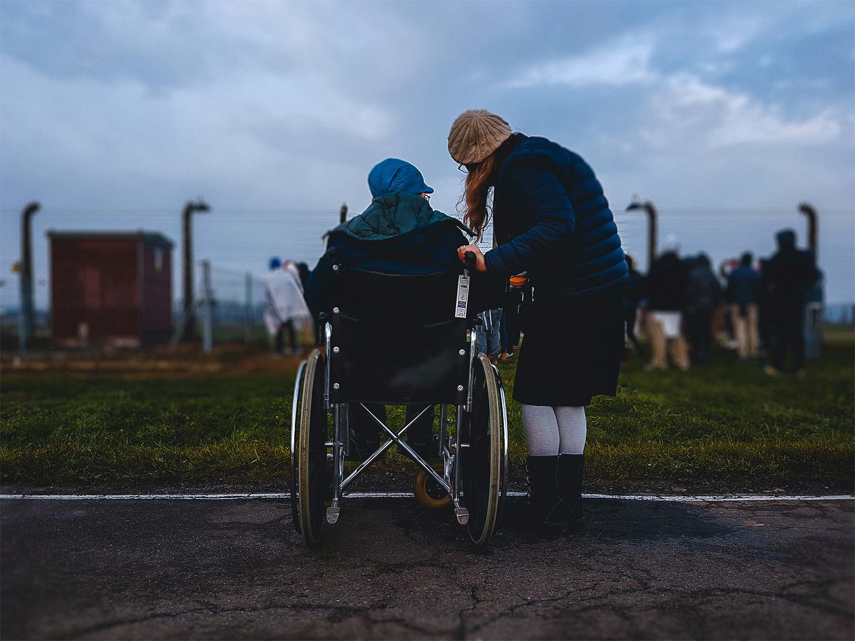 older person in a wheelchair and another standing by them