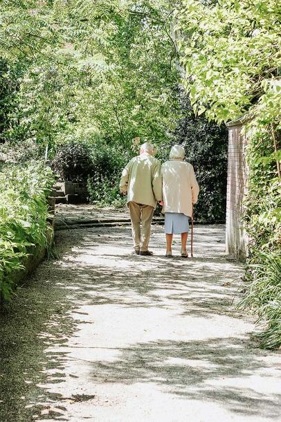 older couple walking down a path